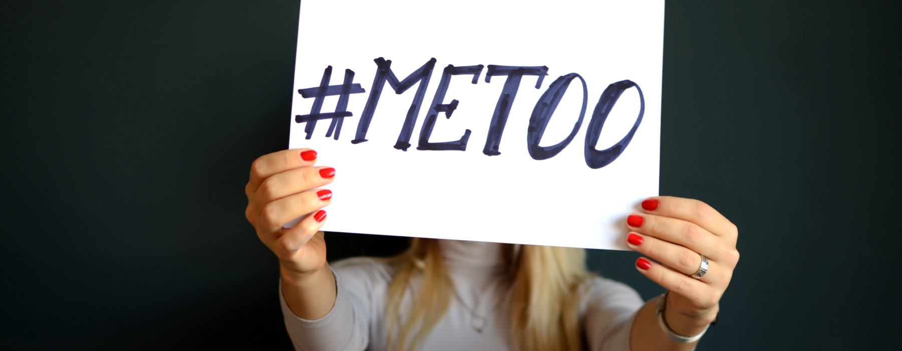 Image of a woman holding a placard for the #meToo campaign