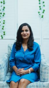 Image of Khushboo Aggarwal sitting on a couch facing the camera
