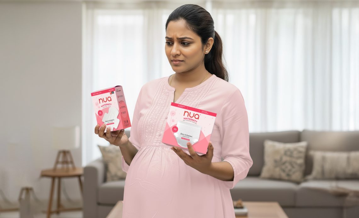 Pregnant woman in a pink outfit holding two Nua maternity products — pads and panties — with a thoughtful expression, comparing options for postpartum care.